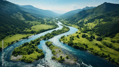 Picturesque river winding through a lush valley, vibrant green foliage along the banks, clear blue water, idyllic and inviting, Photography, aerial sh photo