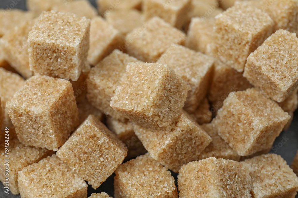 Brown sugar cubes as background, closeup view Brown sugar cubes as background, closeup view