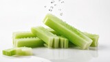 Fresh Chopped Celery Sticks and Slices with Water Drops Isolated on White Background. Vegan and Vegetarian Culture