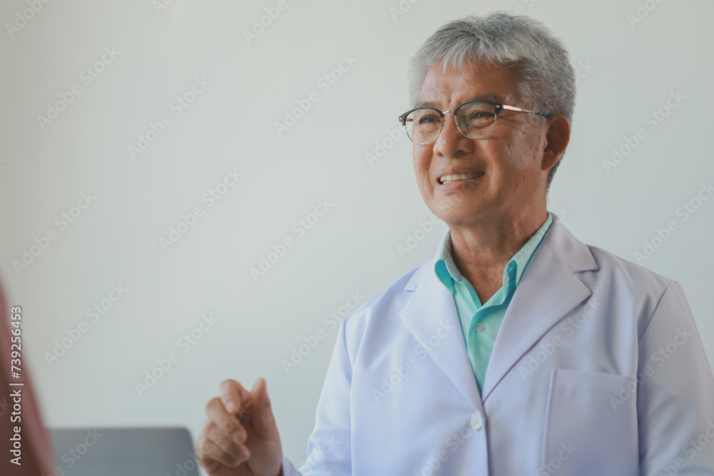 A dignified middle-aged male doctor was sitting in his private office at the hospital, Doctors are sitting and working in various poses. at the hospital happily and happily at work A dignified middle-aged male doctor was sitting in his private office at the hospital, Doctors are sitting and working in various poses. at the hospital happily and happily at work