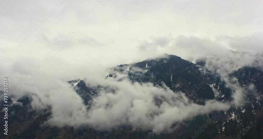 Experience the mesmerizing beauty of monsoon clouds dancing gracefully over majestic mountain peaks in this stunning timelapse footage. Experience the mesmerizing beauty of monsoon clouds dancing gracefully over majestic mountain peaks in this stunning timelapse footage.
