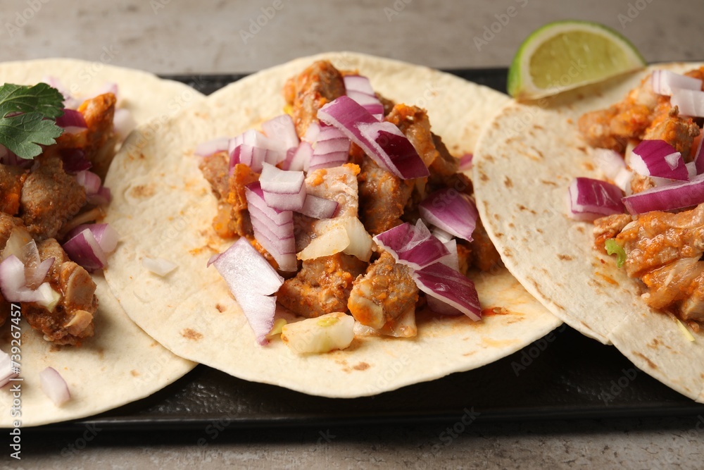 Delicious tacos with vegetables and meat on grey table, closeup Delicious tacos with vegetables and meat on grey table, closeup