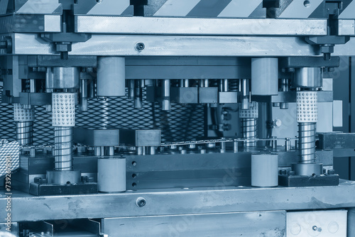 The metalworking process by progressive die in the light blue scene.