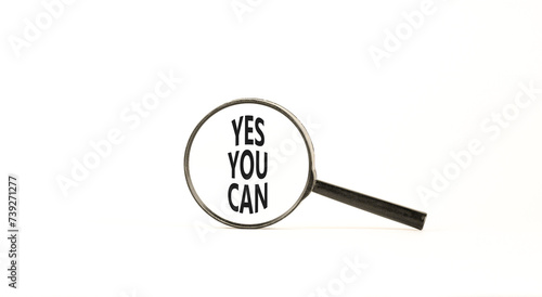 Motivational Yes you can symbol. Concept words Yes you can in beautiful magnifying glass. Beautiful white table white background. Business motivational and Yes you can concept. Copy space