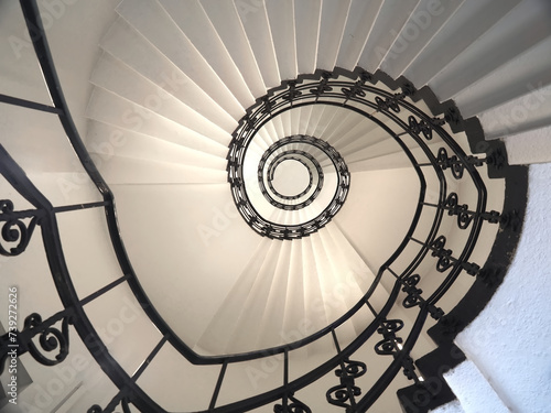 Spiral staircase still life with black ornament railing top view