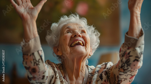 Waist-up shot of happy elderly woman with hands in the air, joyful expression