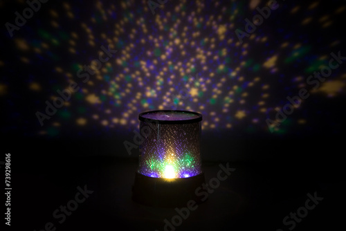 Night light projector, projecting a starry sky onto a ceiling.
