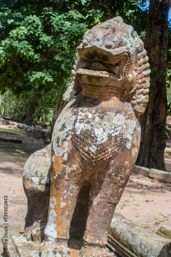 Ancient stone statue of the guardian creature in form of a lion at Angkor Thom temple complex in Cambodia