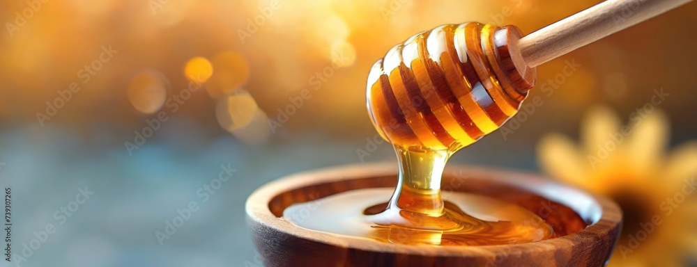 A wooden dipper drips golden honey into a bowl. Glistening amber fluid cascades down from the utensil, reflecting light, against a blurred background suggesting a warm, sunny ambiance. - obrazy, fototapety, plakaty 