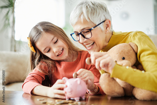 child money saving grandfmother family coin senior finance bank piggybank happy investment granddaughter girl financial elderly cash photo