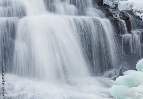 Winter  Bond Falls captured with motion blur and framed by ice and snow  Michigan s Upper Peninsula  USA