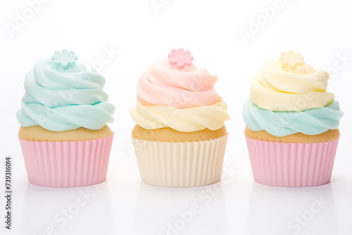 Cupcakes decorated with whipped cream top of pastel colors isolated on white background.