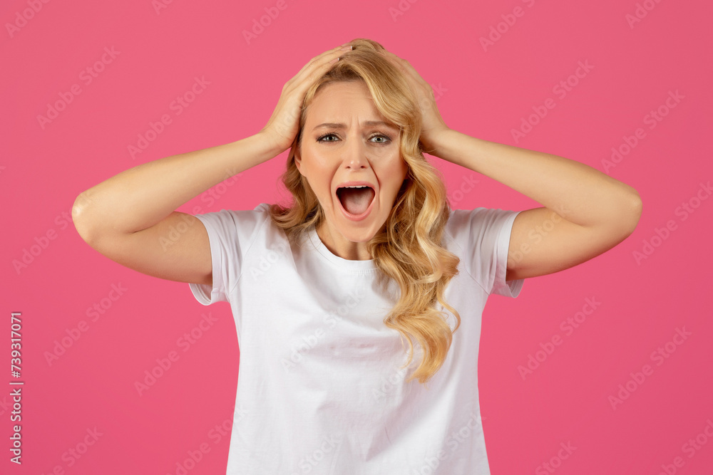 Portrait of desperate angry blonde lady screaming touching head Portrait of desperate angry blonde lady screaming touching head