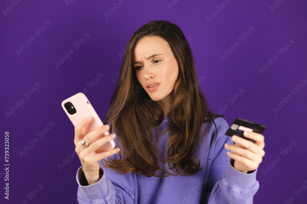 Online payment problem. Shocked frustrated angry lady getting bank card declined blocked. Worried confused female overspending too much money from credit card at web shopping via cell on purple. Online payment problem. Shocked frustrated angry lady getting bank card declined blocked. Worried confused female overspending too much money from credit card at web shopping via cell on purple.