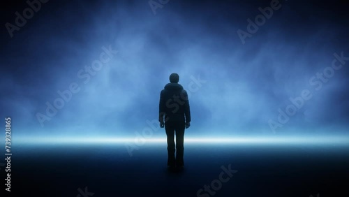 Black silhouette of a man standing alone on dark blue foggy road loop background. photo