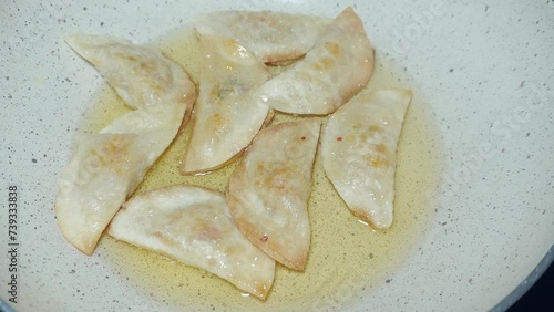 the process of frying Cireng, a snack originating from the Sunda region, Indonesia which is made from a mixture of dough made from tapioca flour photo