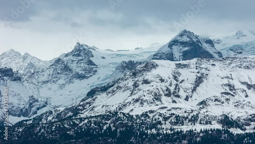 Time lapse of clouds passing mountains. Mountain peak Schwarzhorn, A small glacier named Blau Gletscherli. Bernese Alps, Bernese Oberland, Switzerland. photo