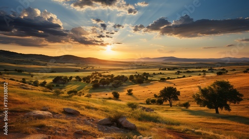 A panoramic view of rolling hills and sun-drenched fields, the setting sun casting a warm golden hue