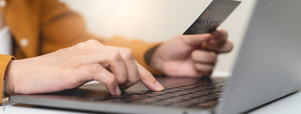 Hands of person entering credit card data laptop computer during pay for internet shopping online at home. Hands of person entering credit card data laptop computer during pay for internet shopping online at home.