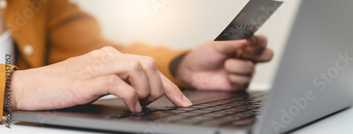 Canvas Print Hands of person entering credit card data laptop computer during pay for internet shopping online at home