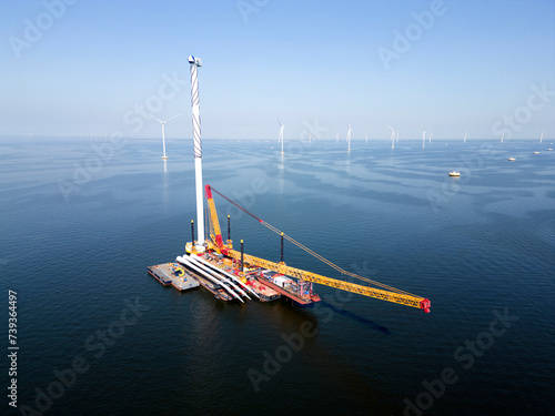 A transport ship and crane for constructing an offshore windpark photo