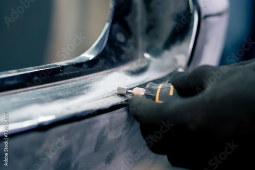 close-up at a service station grinding a rubber gasket on a metal part of the machine with a milling cutter