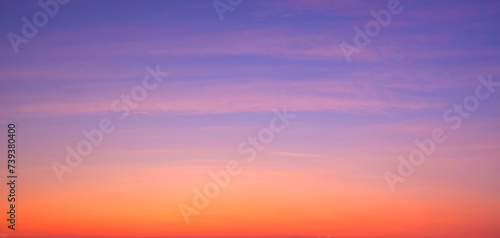 Beautiful evening sky background with colorful sunset cloud on dramatic twilight sky in panoramic view  © Prapat
