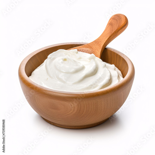 sour cream in wooden bowl and spoon, mayonnaise, yogurt, isolated on white background, clipping path, full depth of field