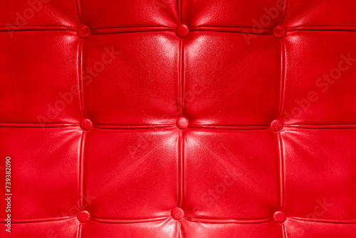 Texture of luxury red leather with drawstrings and buttons as a background.
