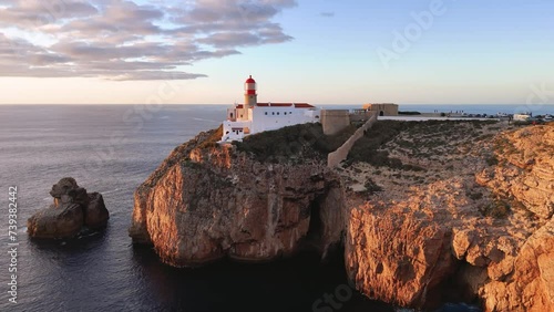 Flight towards the Cabo de Sao Vicente fort and lighthouse at sunset, Portugal  photo