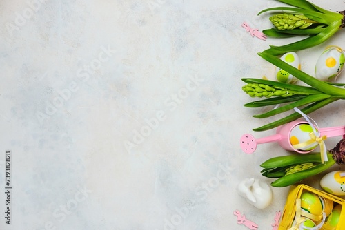 Easter background with hyacinths, Easter decor and decorative watering can on a light background with space for text. Top view, advertising card, postcard.