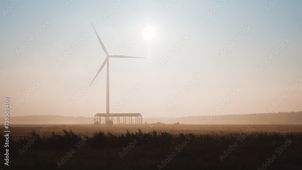 Windturbine in a field in a foggy summer morning, Latvia Windturbine in a field in a foggy summer morning, Latvia