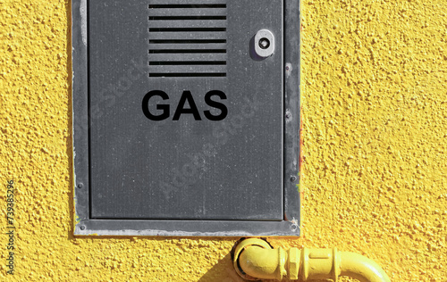 door of gas meters with the text GAS and the yellow tube photo