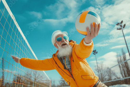 Happy elderly man playing volleyball