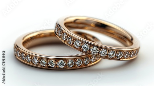 Two Gold Wedding Rings With Diamonds on a White Background