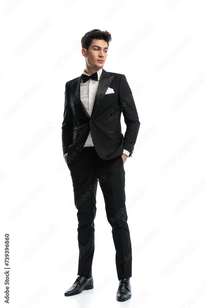 elegant fashion man in black tuxedo holding hands in pockets elegant fashion man in black tuxedo holding hands in pockets