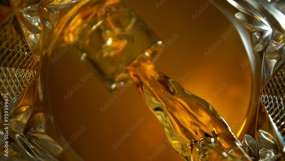 Freeze Motion Shot of Whiskey Liquid Pouring, Macro, Unique Angle of View from the Bottom of the Glass Freeze Motion Shot of Whiskey Liquid Pouring, Macro, Unique Angle of View from the Bottom of the Glass
