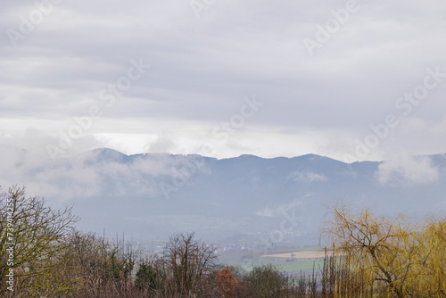View from Marktgräflerland in the Rhine Valley to the cloud-covered mountains of the Black Forest