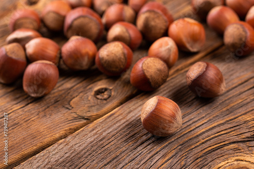 Hazelnuts in shell close-up. Hazelnut on wooden background.