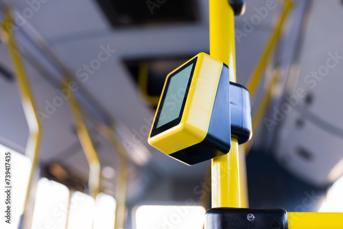 Payment terminal in the bus, non-cash payment for travel in public transport. Bus with validator for self-payment. Fare control without a conductor. Public city passenger transport. photo