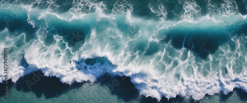 aerial view of beautiful photo of blue water flowing in waves with white foam in a ocean. 