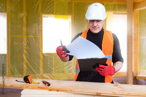 Man builder works with wood...