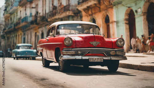 retro red car on a sunny street in havana, cuba 
