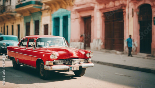 retro red car on a sunny street in havana, cuba 