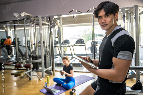 Fitness trainer man working in gym 