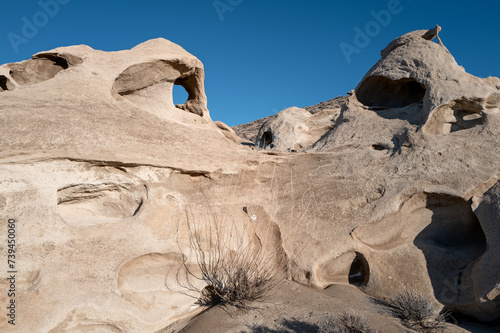 Unique eroded patters in rock with blue sky photo