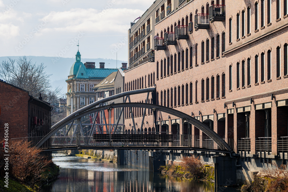 The beautiful city of Bielsko-Biala. Biala River, steel bridges. Art Nouveau tenement houses and mountains in the background. The capital of the Silesian Beskids
