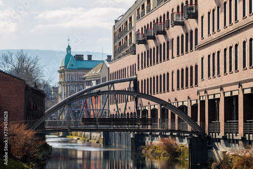 Obraz na płótnie The beautiful city of Bielsko-Biala. Biala River, steel bridges. Art Nouveau tenement houses and mountains in the background. The capital of the Silesian Beskids w salonie