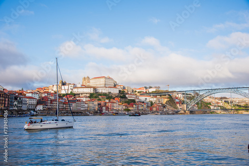 A yacht on the Douro River in Porto, in front of the Luís I Bridge