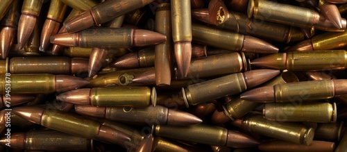 A chaotic pile of shiny metallic bullets illustrating danger and violence